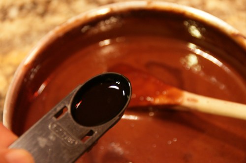 The vanilla may bubble a bit, but don't worry about it.  Just go ahead and stir it in!