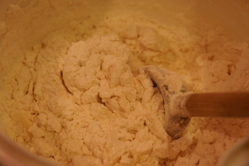 Mix in with a wooden spoon; a mixer will toughen the dough too much