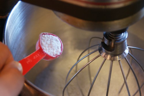 Cream of tartar is acidic and stabilizes the whipped whites (less deflating = lighter cake)