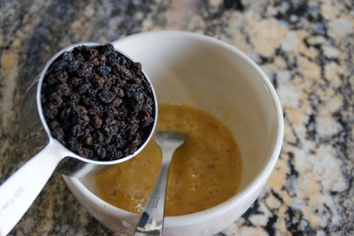 The beaten eggs will be colored by the currants as they soak.