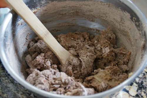 Add the flour in two batches if doing by hand (it's easier) and rotate the bowl with one hand while mixing with the other.