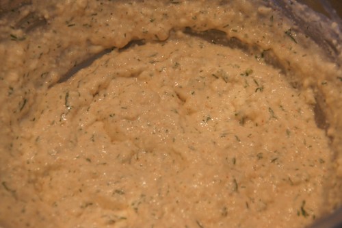 Use a spatula to mix in the salmon; you can break up the meat further by pressing the fish against the sides of the bowl