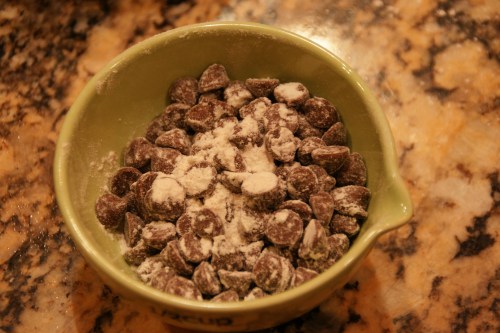 The flour allows the chips to remain suspended in the batter instead of falling to the bottom of the pan