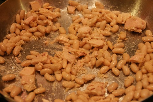 Break up the tuna with a wooden spoon