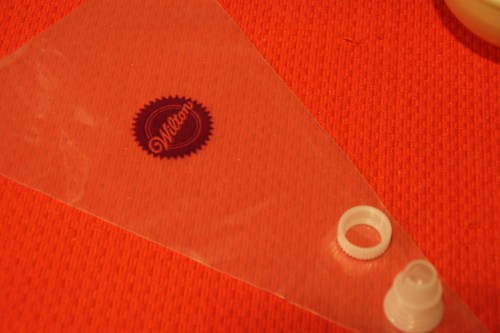 Use the cone-shaped part of the coupler (the piece that goes into the pastry bag)