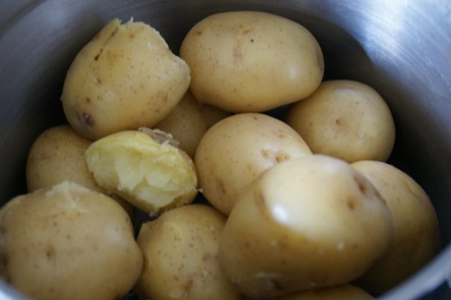 Let these cook until you can hold them to peel