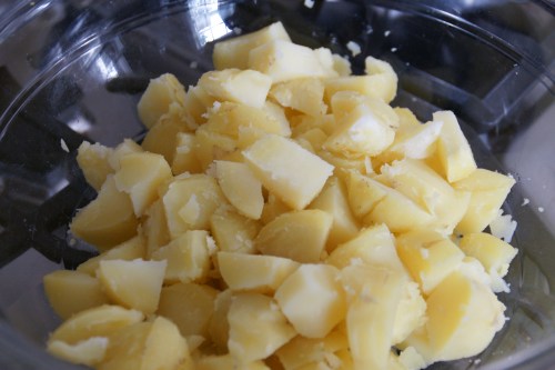 Warm potatoes. I cut mine into fairly big chunks since they break apart a bit when mixed with the other goodies