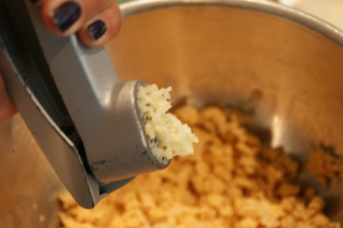 A garlic press gives you the most intense garlic flavor; large pieces give less flavor